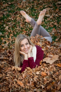 Hannah in the leaves outdoors at the studio.