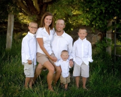 A family picture outdoors in the pasture at Addison Photography.
